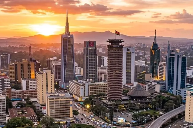 Nairobi city centre at sunset with towers, a park and a busy road