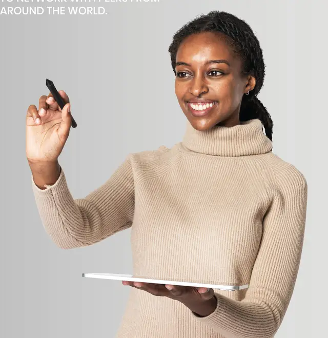 Smiling teacher holding a tablet and writing on a virtual board