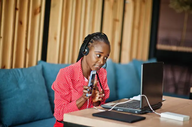 Virtual assistant with a headset working on a laptop
